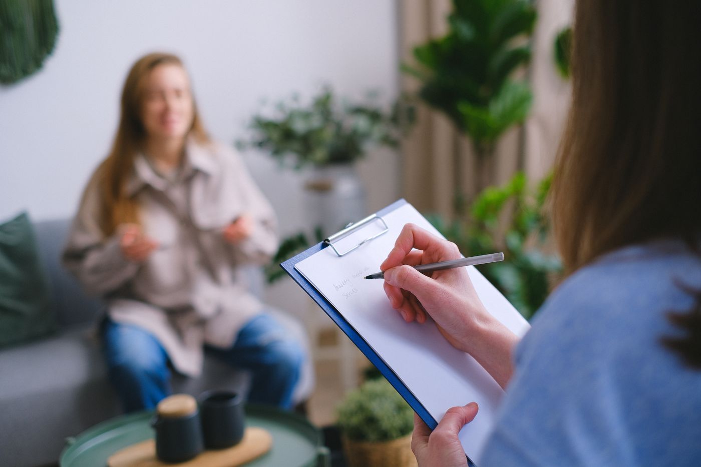 A therapist taking notes during an intake consultation